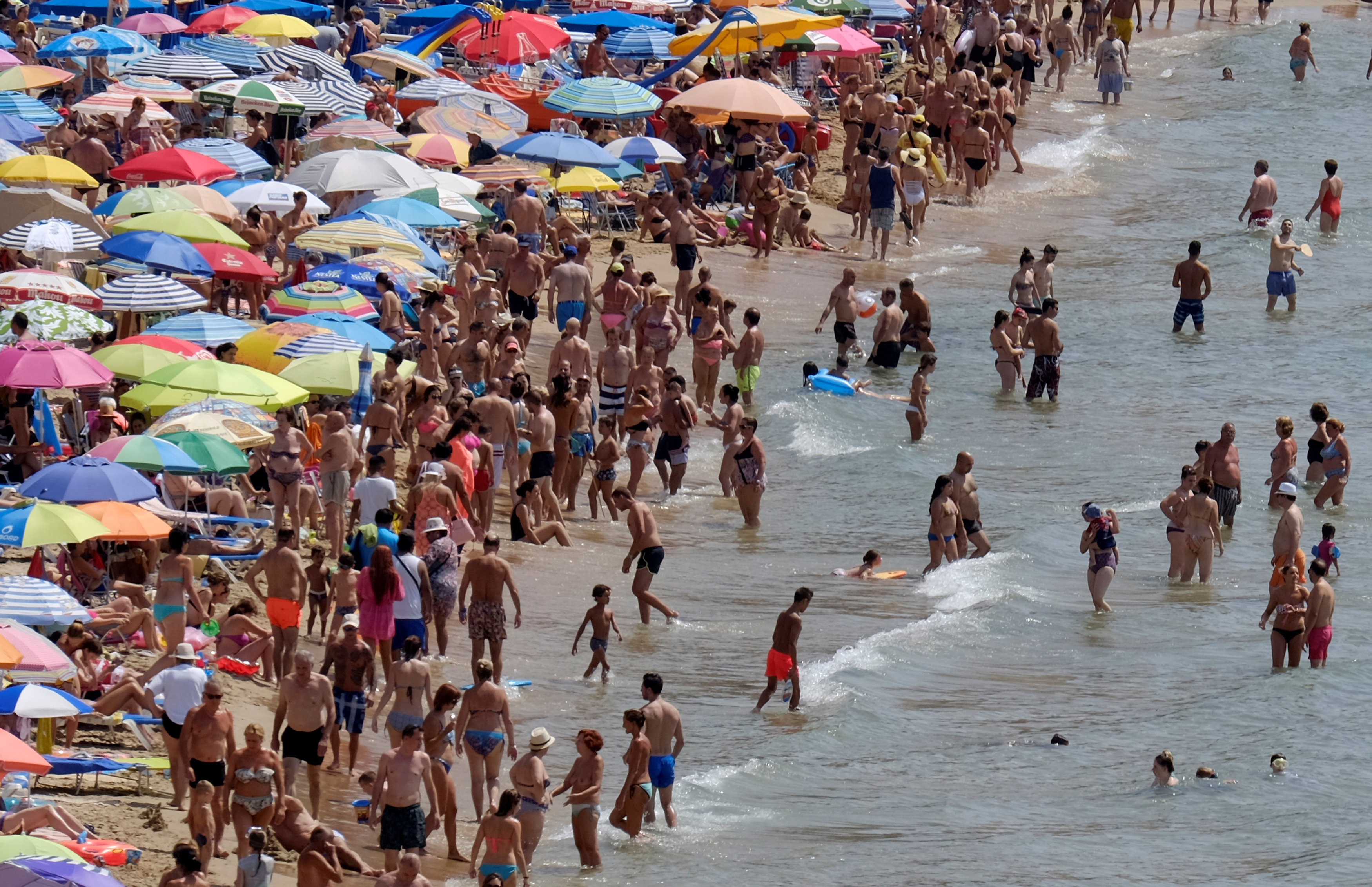 People enjoy the beach in the southeastern city of Benidorm