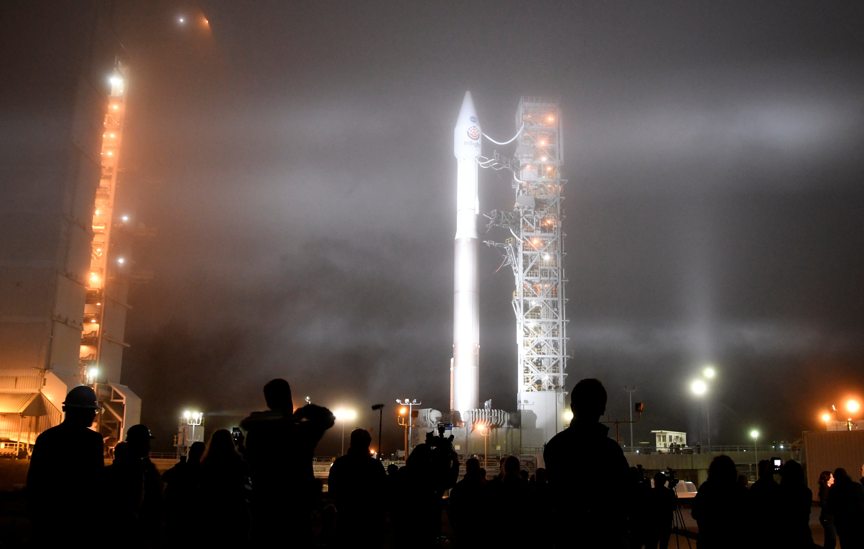 Heavy fog rolls in during tower rollback of a United Launch Alliance Atlas V rocket with InSight Mars lander onboard before lifting off from Vandenberg Air Force base in California