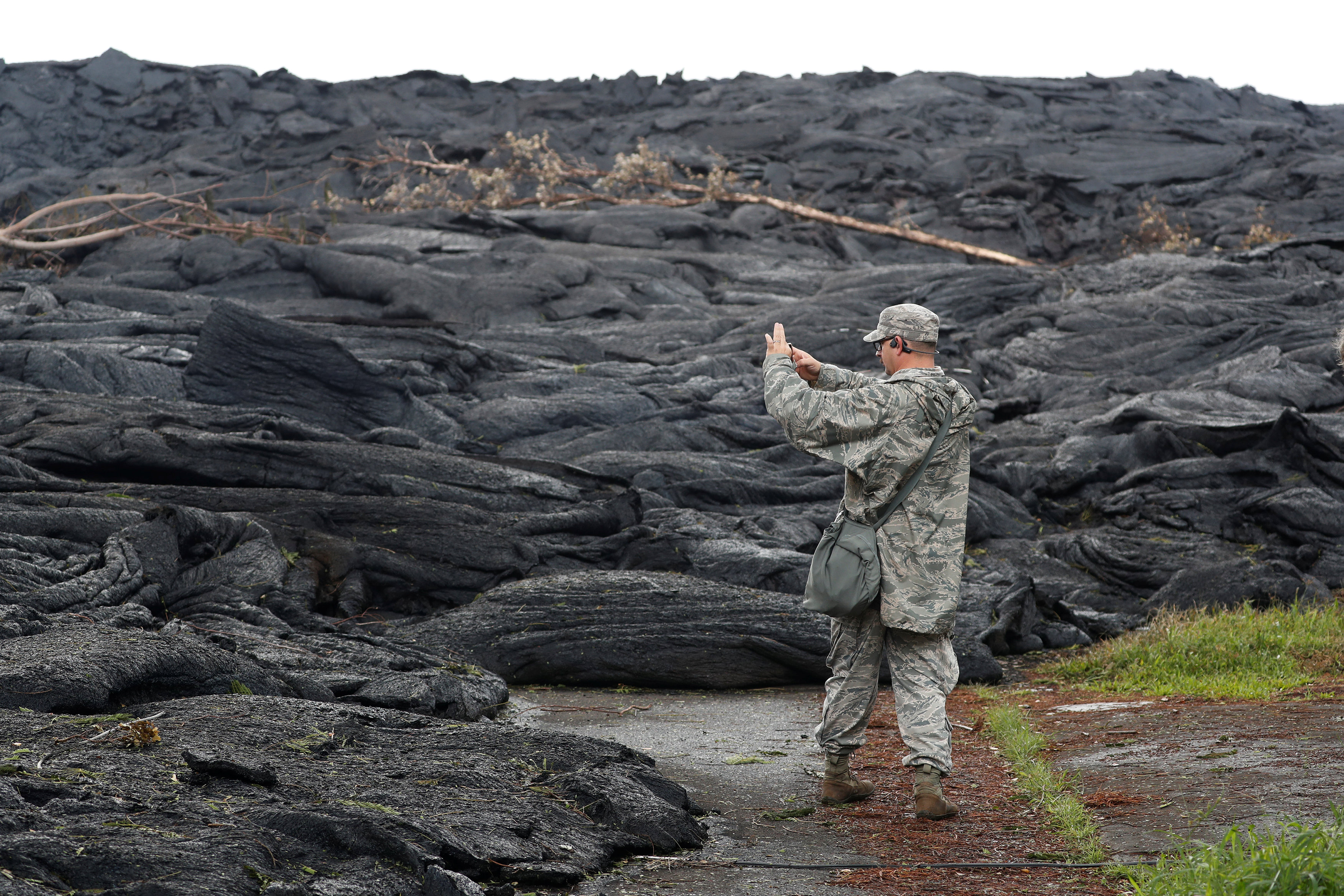 Tech Sgt. Andrew Lee Jackson, of the Hawaii National Guard, takes photos of the Kilauea lava flow, in Leilani Estates near Pahoa, Hawaii