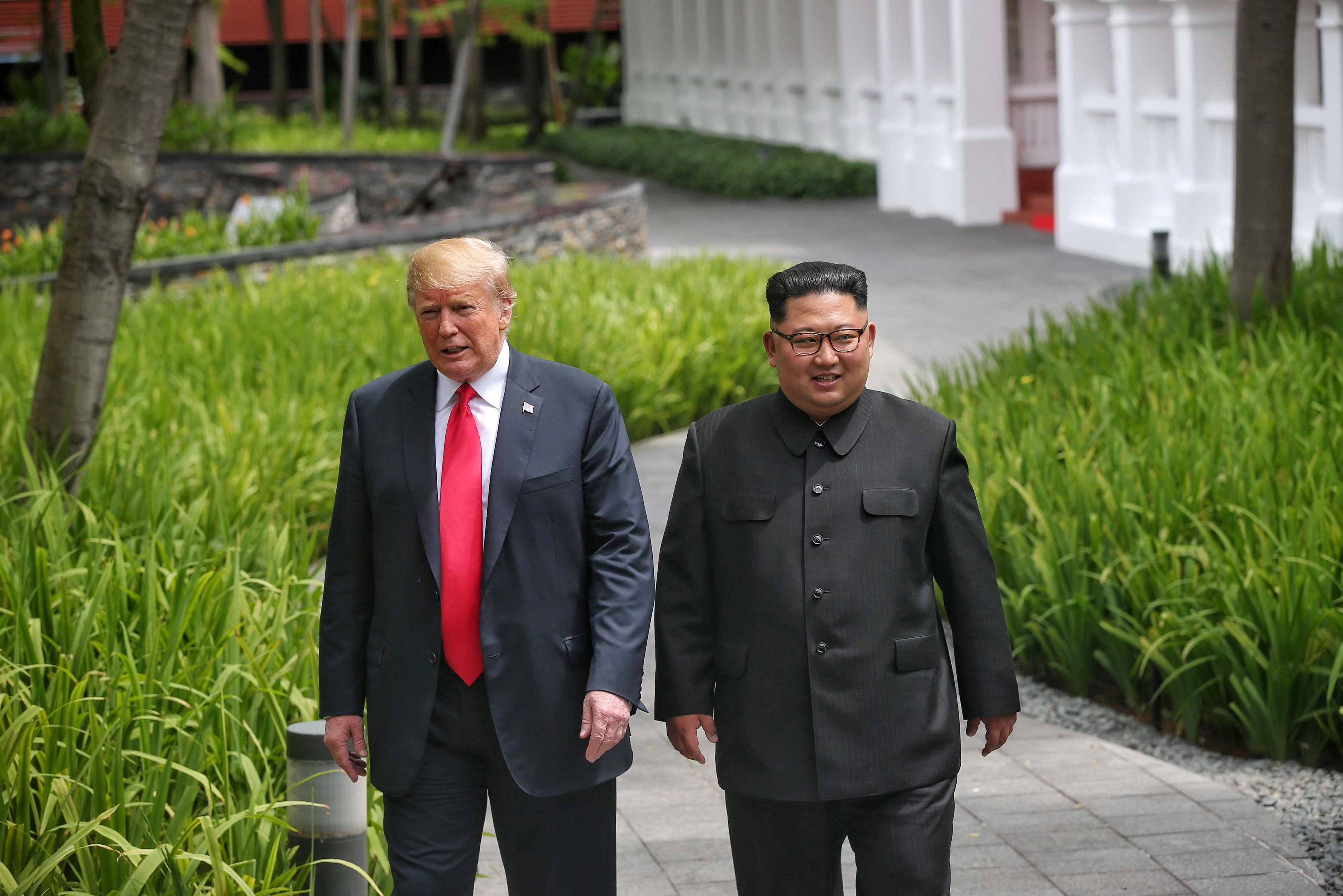 U.S. President Donald Trump walks with North Korean leader Kim Jong Un at the Capella Hotel on Sentosa island in Singapore