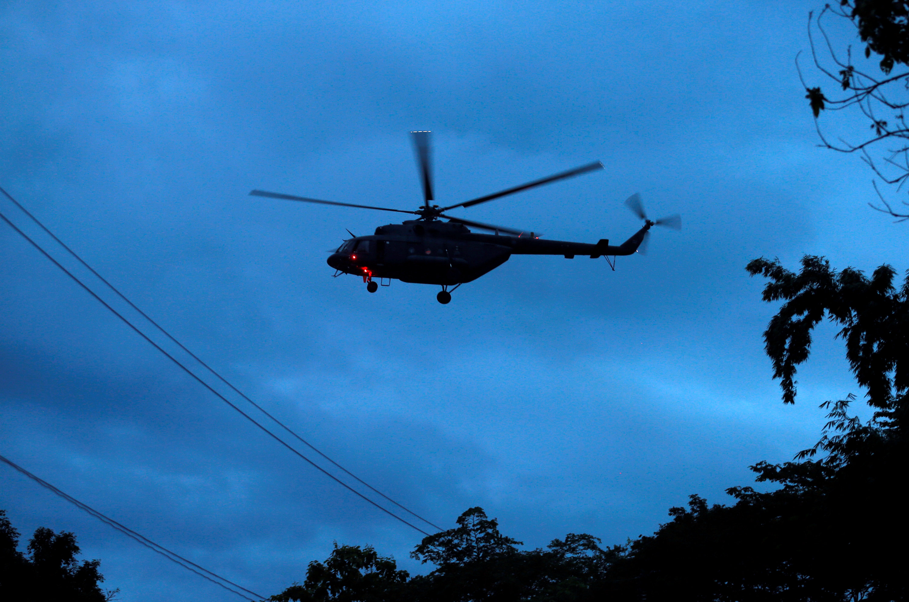 A military helicopter believed to be carrying rescued schoolboys takes off near Tham Luang cave complex in the northern province of Chiang Rai