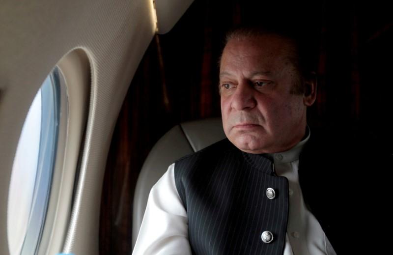 FILE PHOTO: Pakistani Prime Minister Nawaz Sharif looks out the window of his plane after attending a ceremony to inaugurate the M9 motorway between Karachi and Hyderabad
