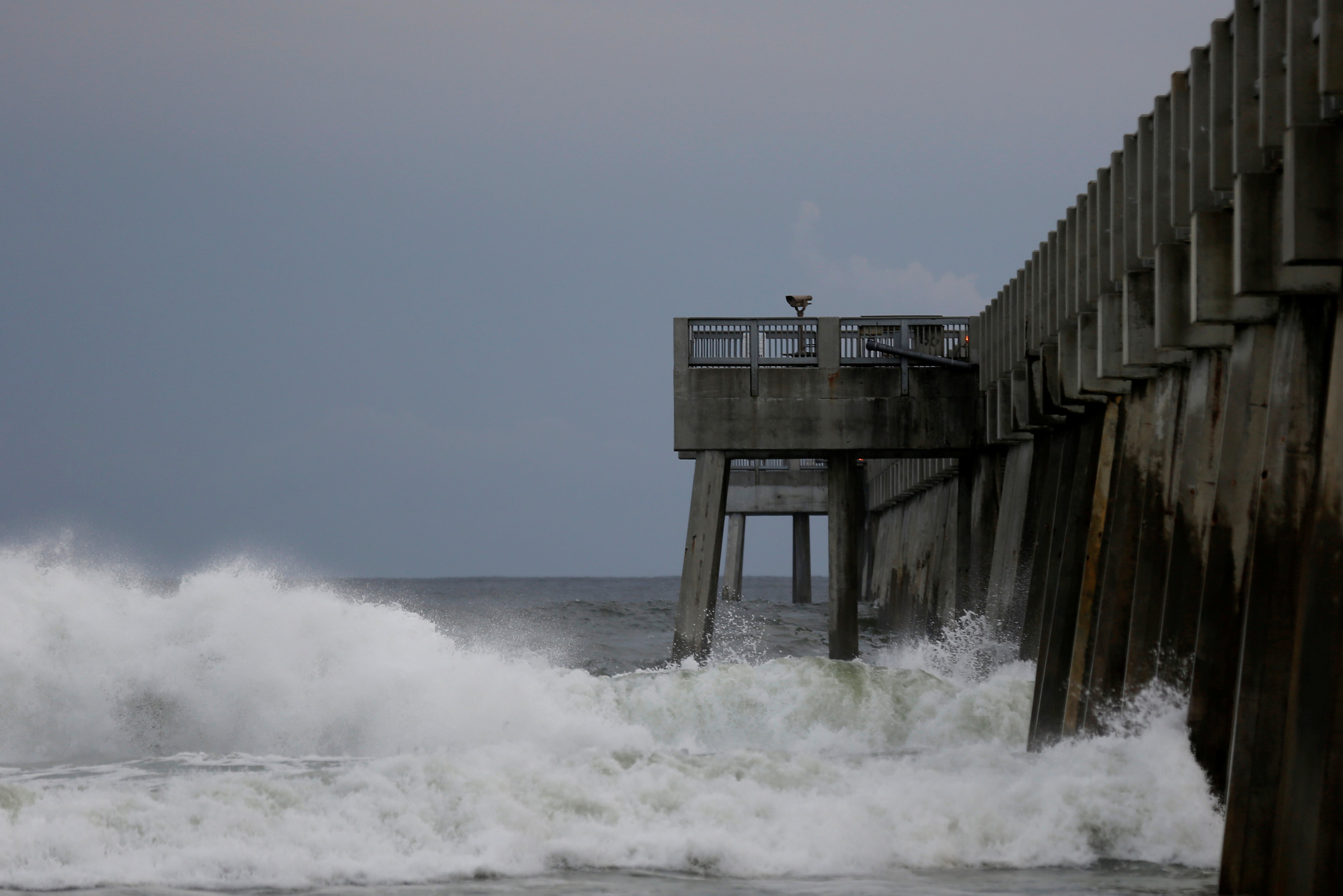 Waves crash along a pier as Hurricane Michael approaches Panama City Beach