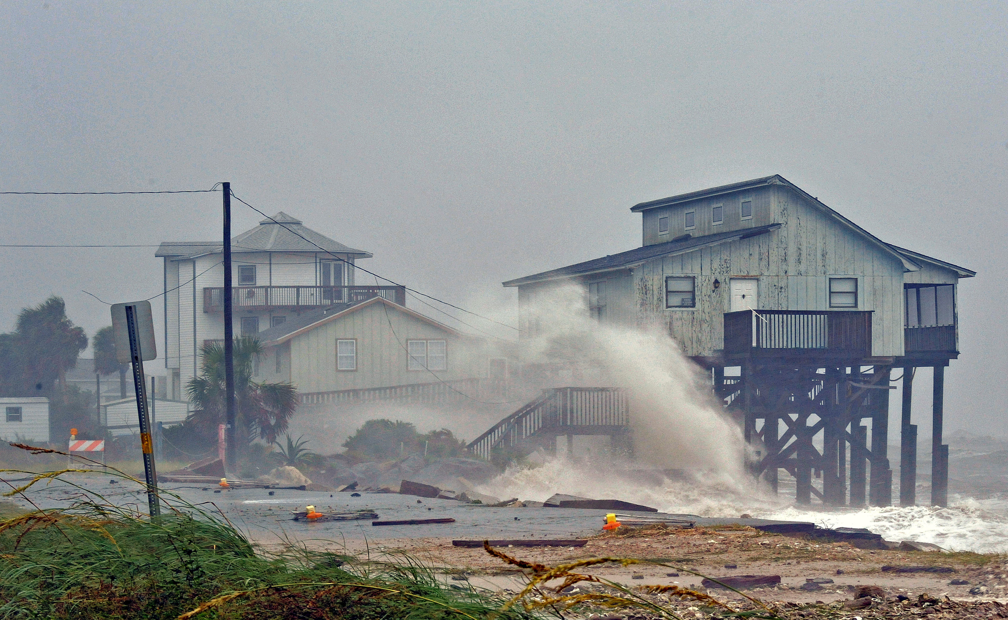 Waves crash on stilt houses along the shore due to Hurricane Michael at Alligator Point in Franklin County