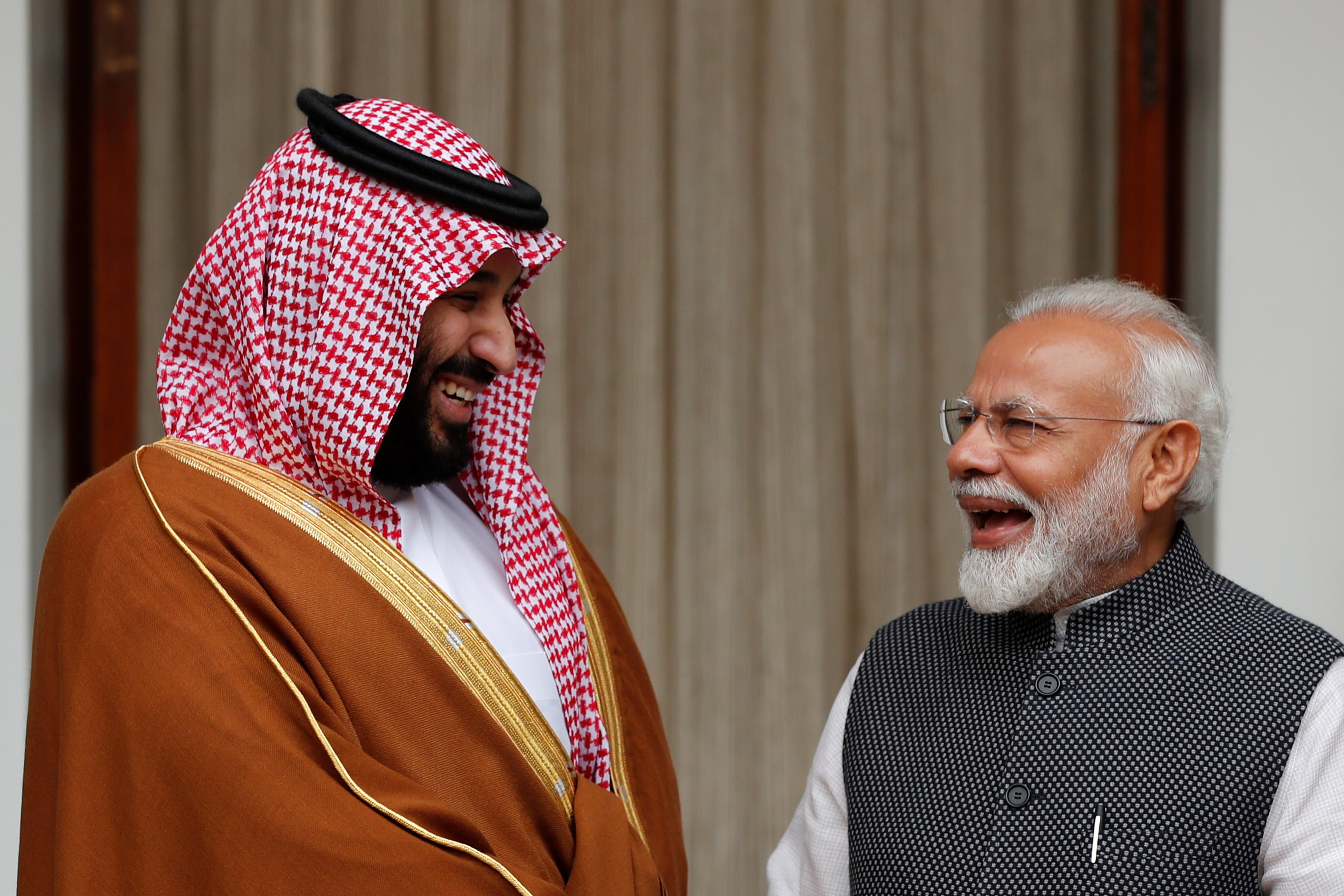 Saudi Arabia's Crown Prince Mohammed bin Salman and India's Prime Minister Narendra Modi react ahead of their meeting at Hyderabad House in New Delhi