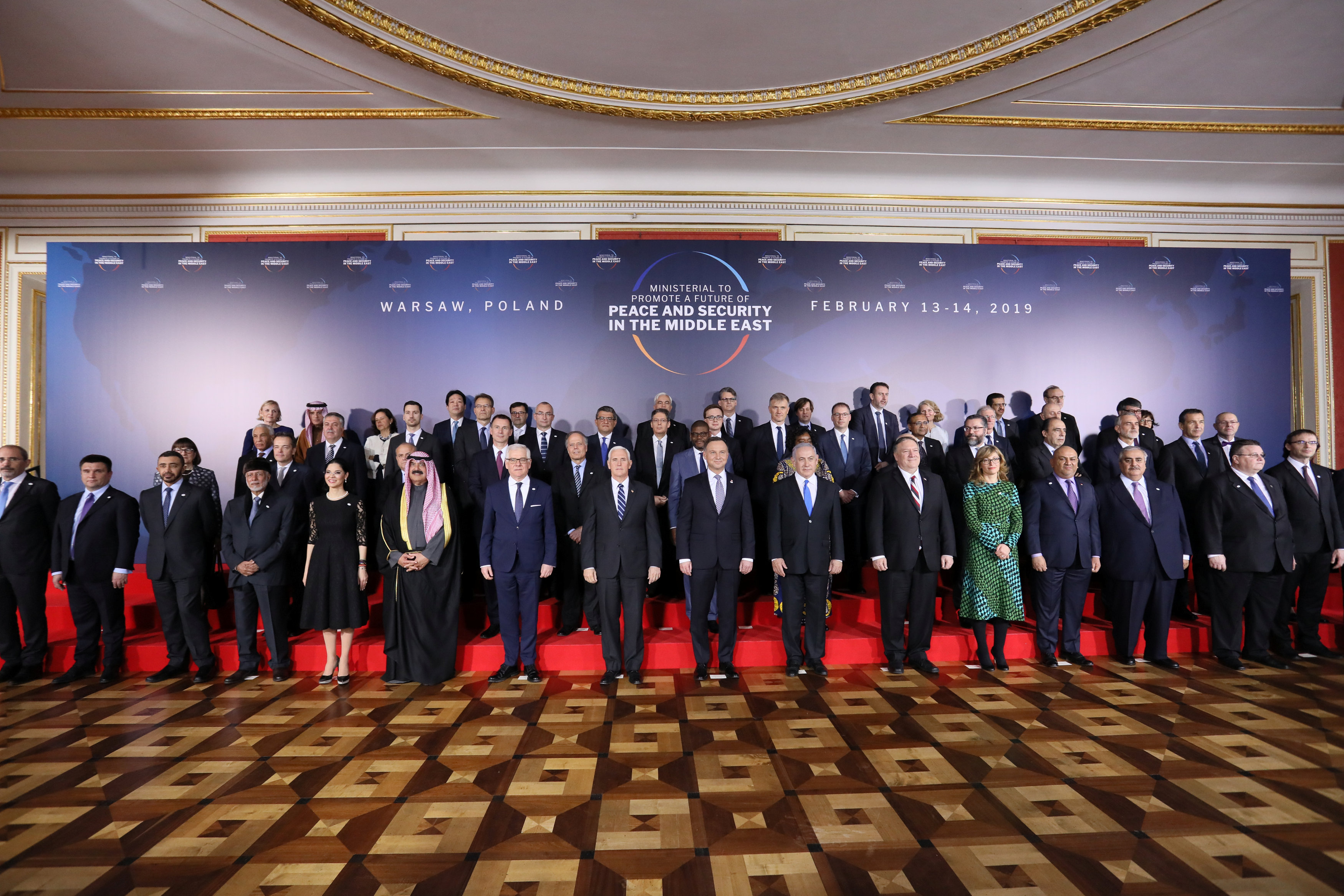 Participants pose for family photo at the Middle East conference at the Royal Castle in Warsaw