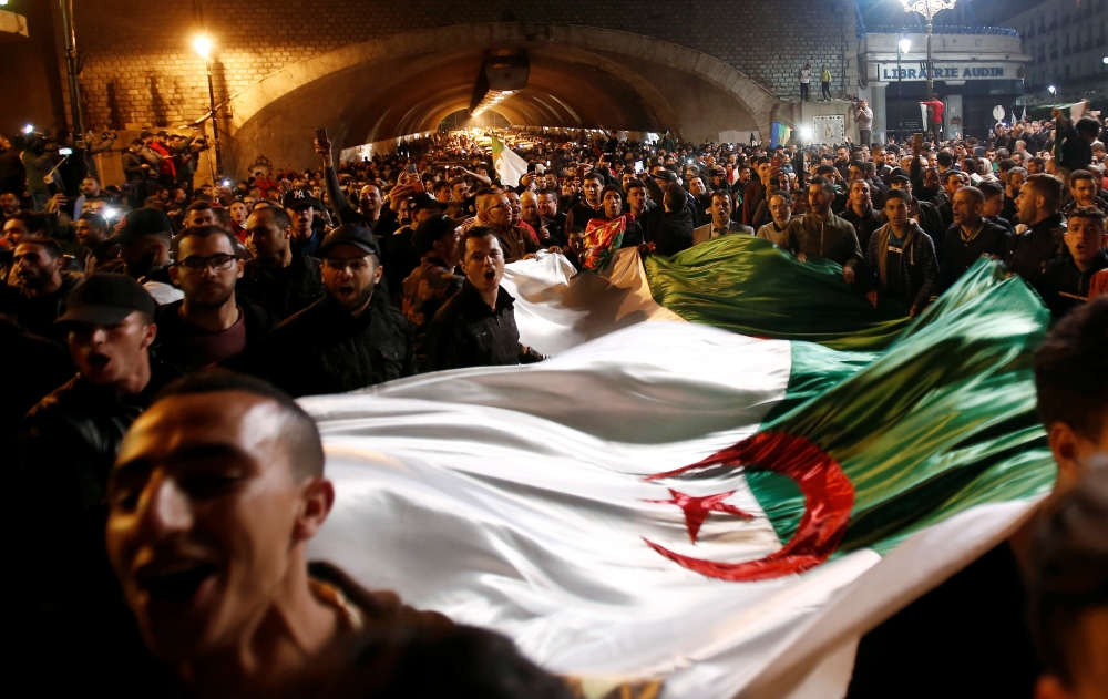 People celebrate after Algeria's President Abdelaziz Bouteflika has submitted his resignation, in Algiers