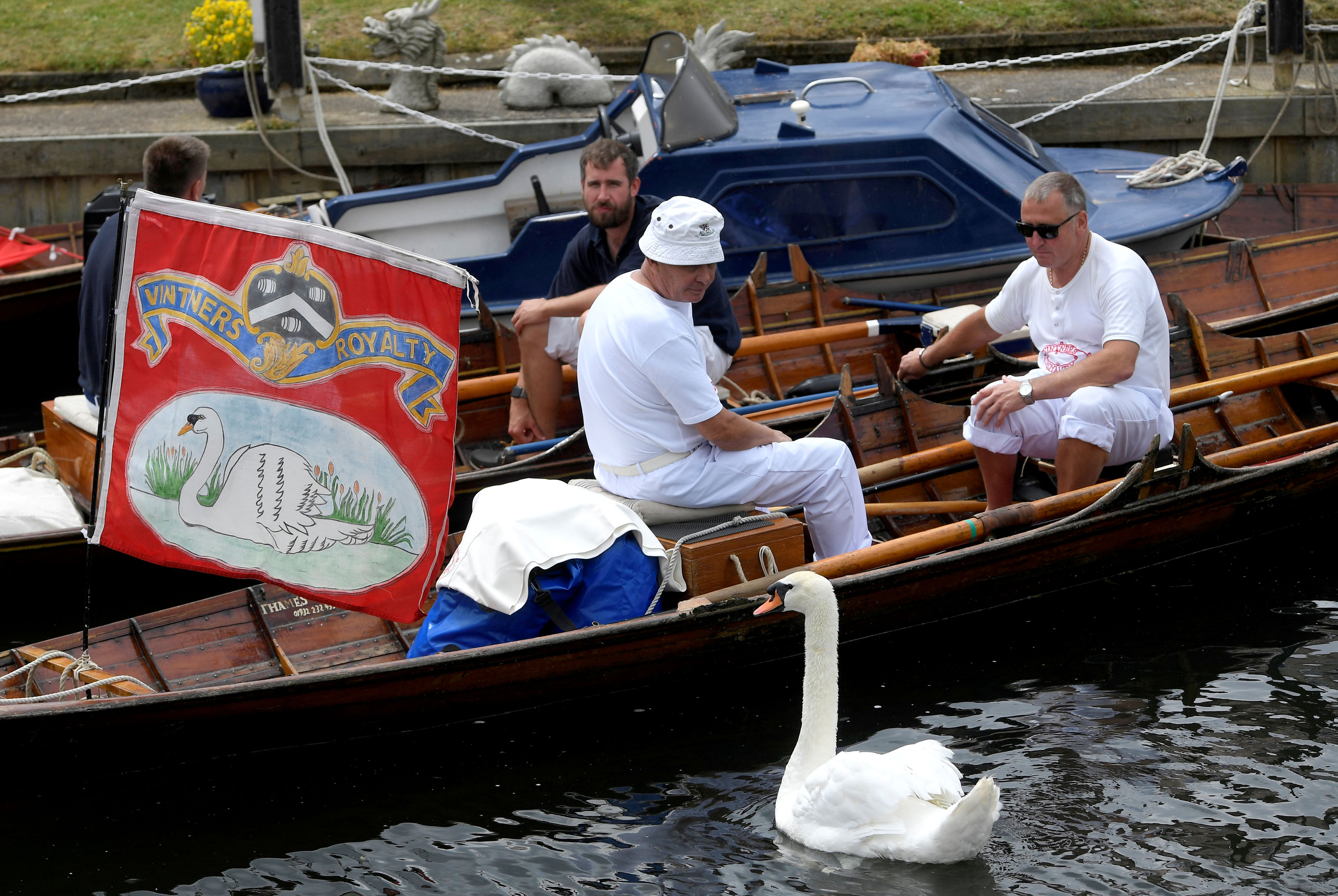 Officials take a break during the annual counting of the Queen's swans, known as 'Swan Upping' along the River Thames in London