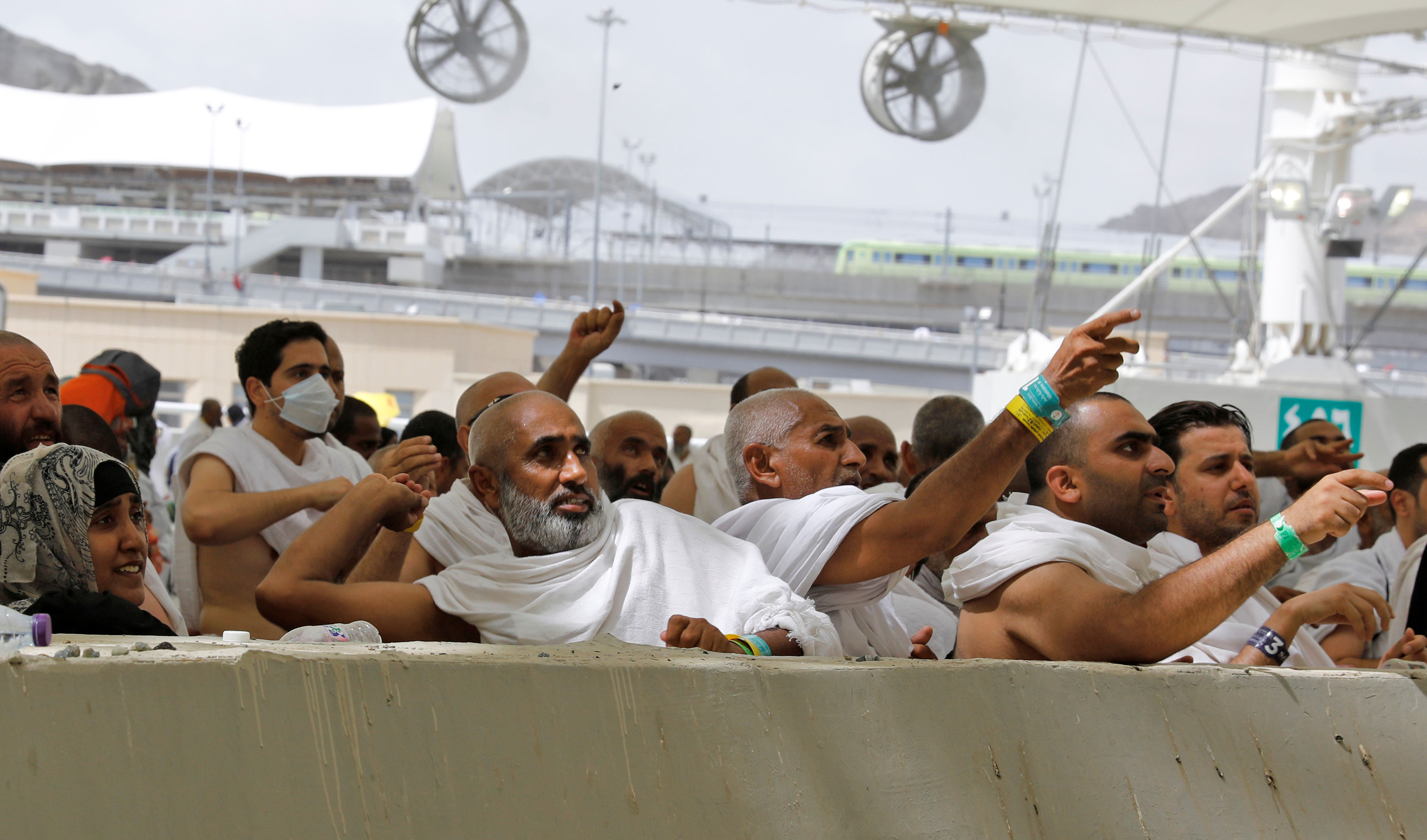 Muslim pilgrims cast their stones at a pillar symbolising the stoning of Satan during the annual haj pilgrimage in Mina