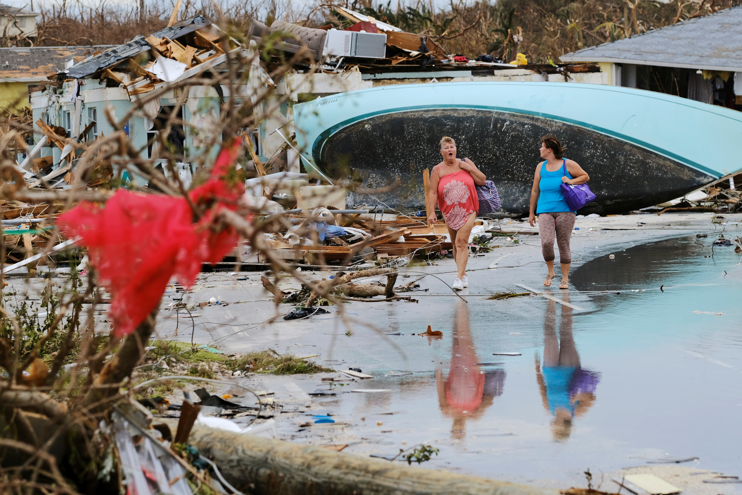 Women walk through the rubble in the aftermath of Hurricane Dorian on the Great Abaco island town of Marsh Harbour