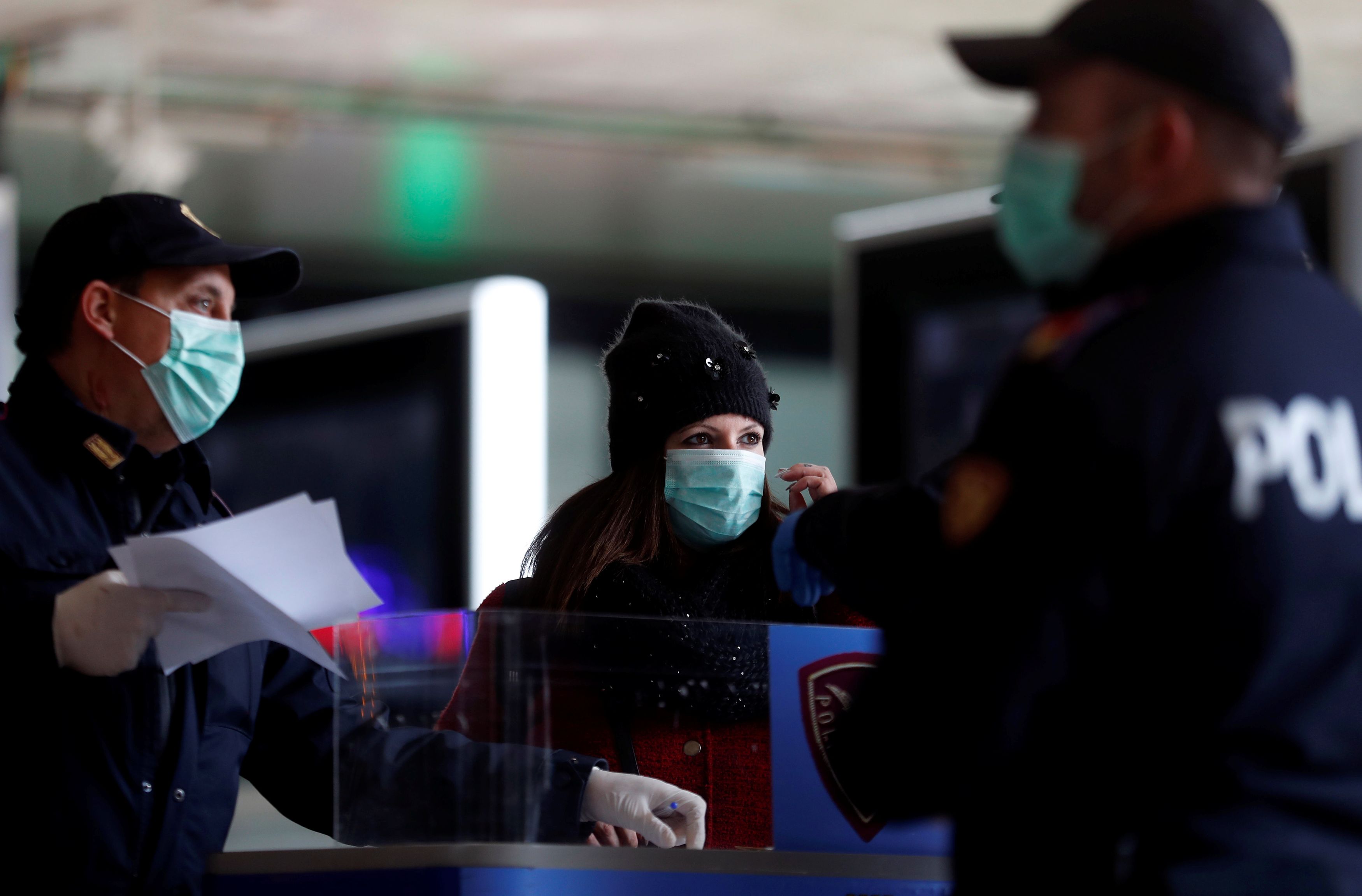 People arriving at the Roma Termini railway station have their self-certifications checked by police in Rome