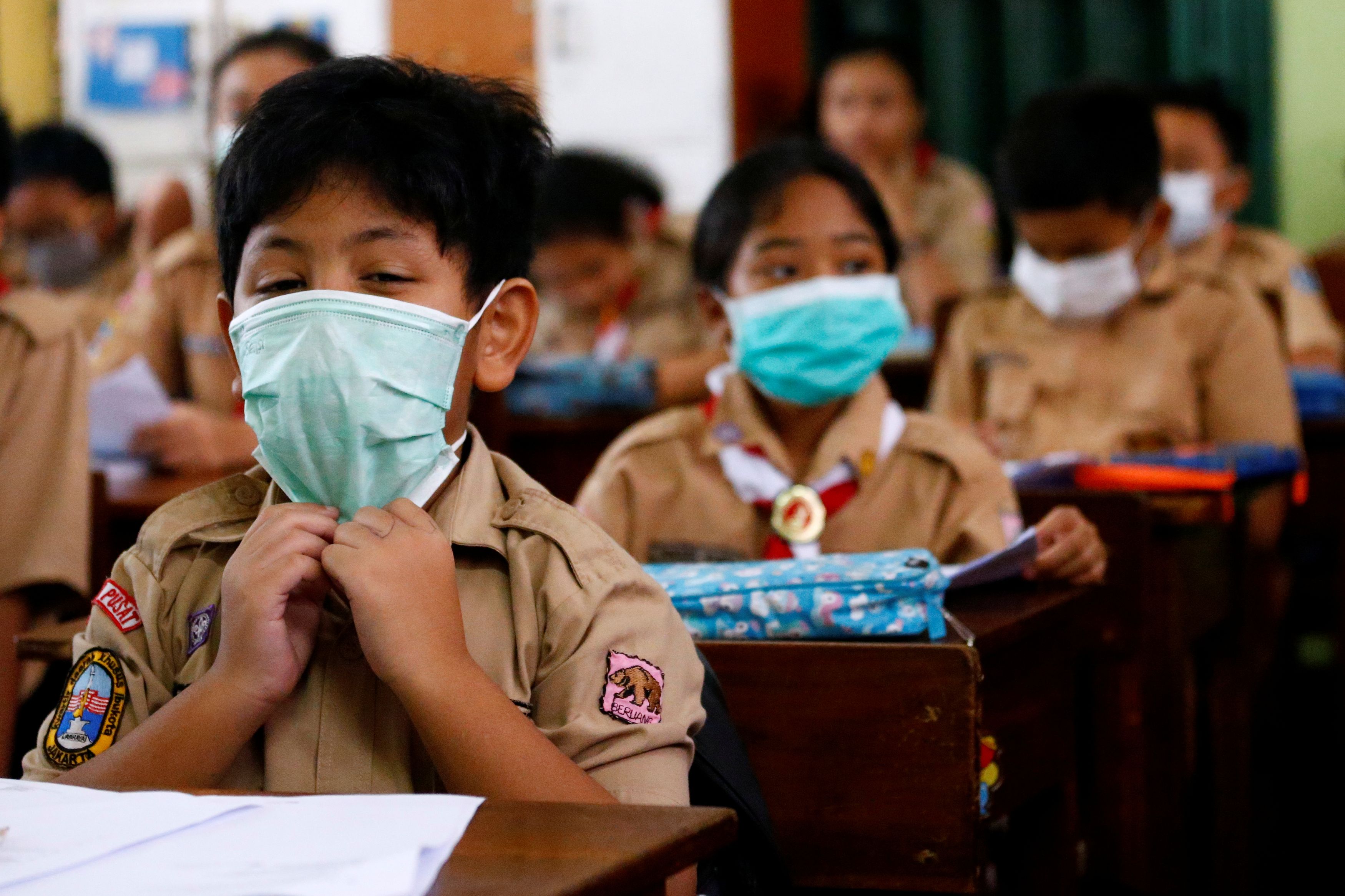 Students wear protective masks in school after Indonesia confirmed its first cases of the novel coronavirus disease of COVID-19, in Jakarta