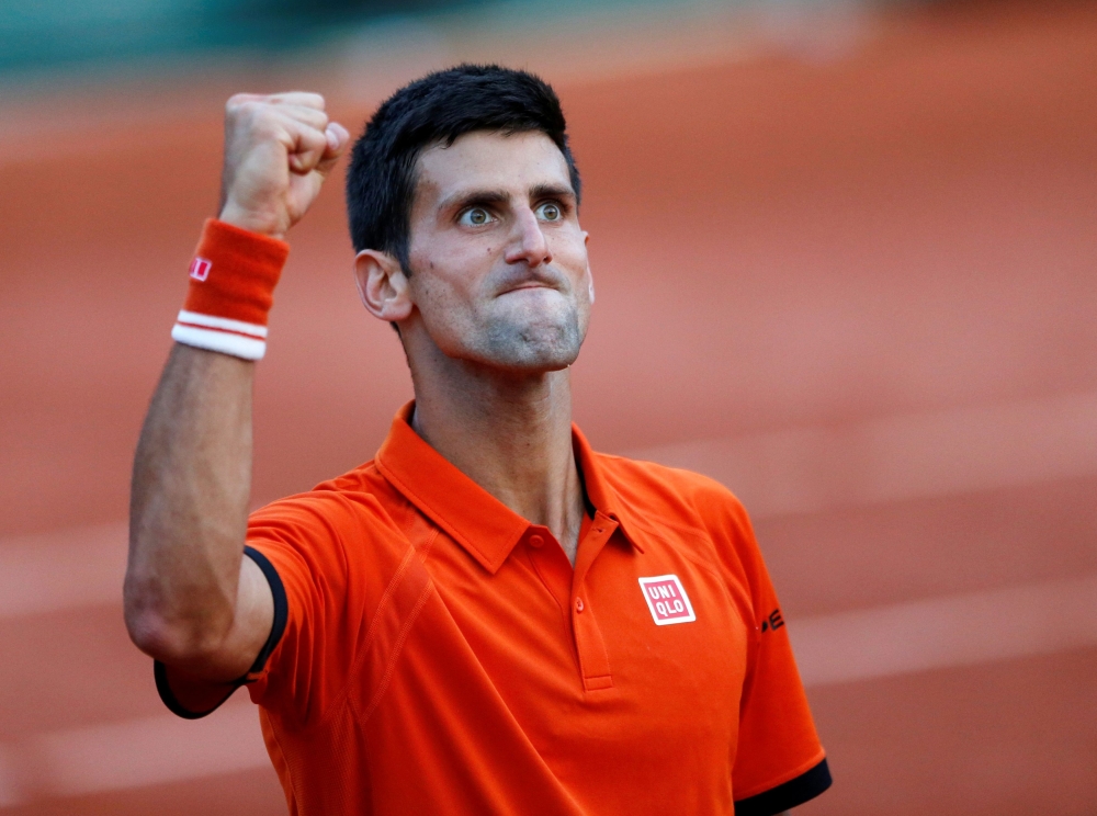 FILE PHOTO: Novak Djokovic celebrates after his 6-3 6-3 5-7 5-7 6-1 victory over Andy Murray in the French Open semi-final.
