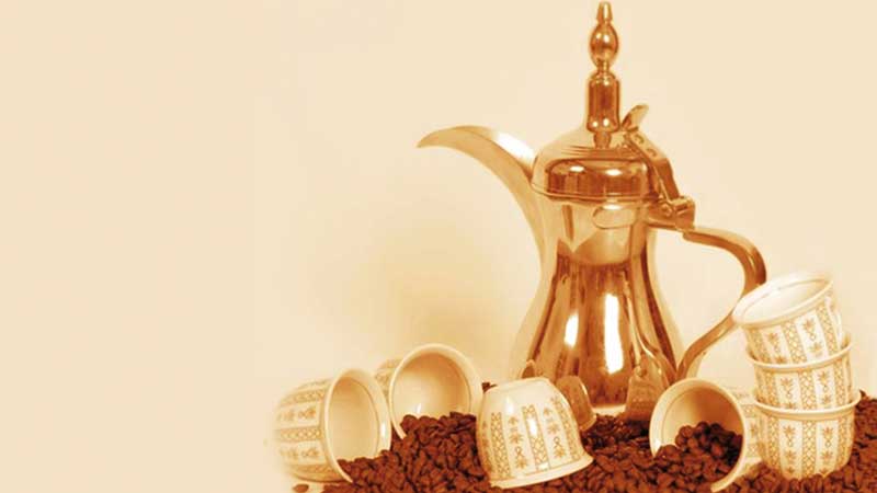a_dallah_a_traditional_arabic_coffee_pot_with_cups_and_coffee_beans