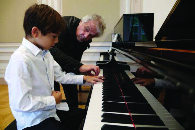 Guillaume Benoliel, a six-year-old child, practices the piano with his teacher Serguei Kouznetsov during a lesson at the conservatory in Yerres