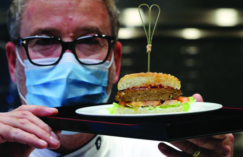 Chef Brunschweiler displays a pea protein-based hamburger at flavour maker Givaudan's innovation centre in Kemptthal